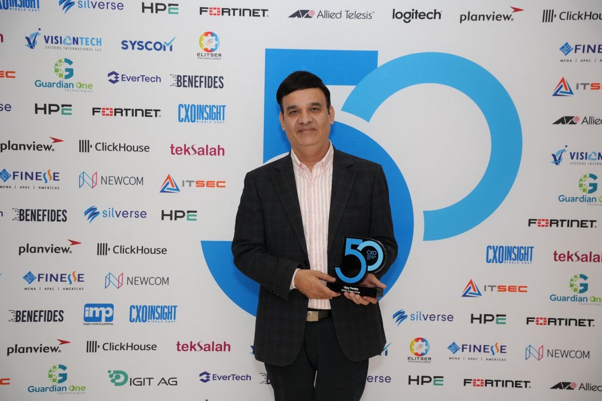 Vijay Pandey with CXO 50 trophy at sponsor wall